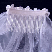 Romantic layered wedding veil with delicate floral lace trim