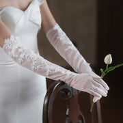 Elegant sheer floral bridal gloves for wedding portraits