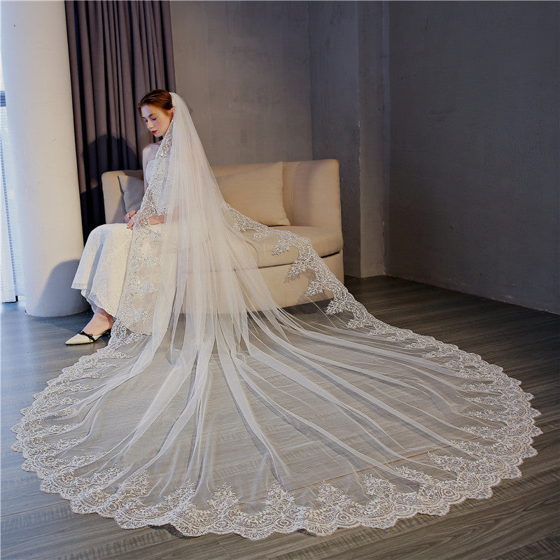 Celestine lace cathedral bridal veil with floral lace train styled with a wedding gown