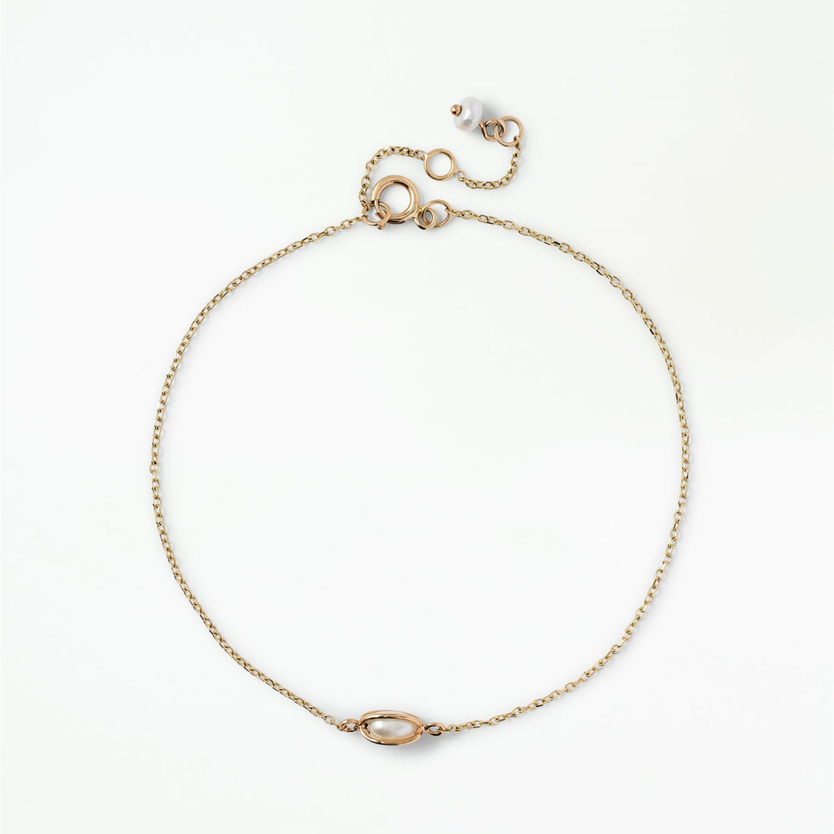 Margot gold-tone minimalist chain bracelet with an oval centerpiece and petite pearl-inspired charm