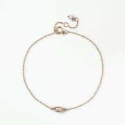 Margot gold-tone minimalist chain bracelet with an oval centerpiece and petite pearl-inspired charm