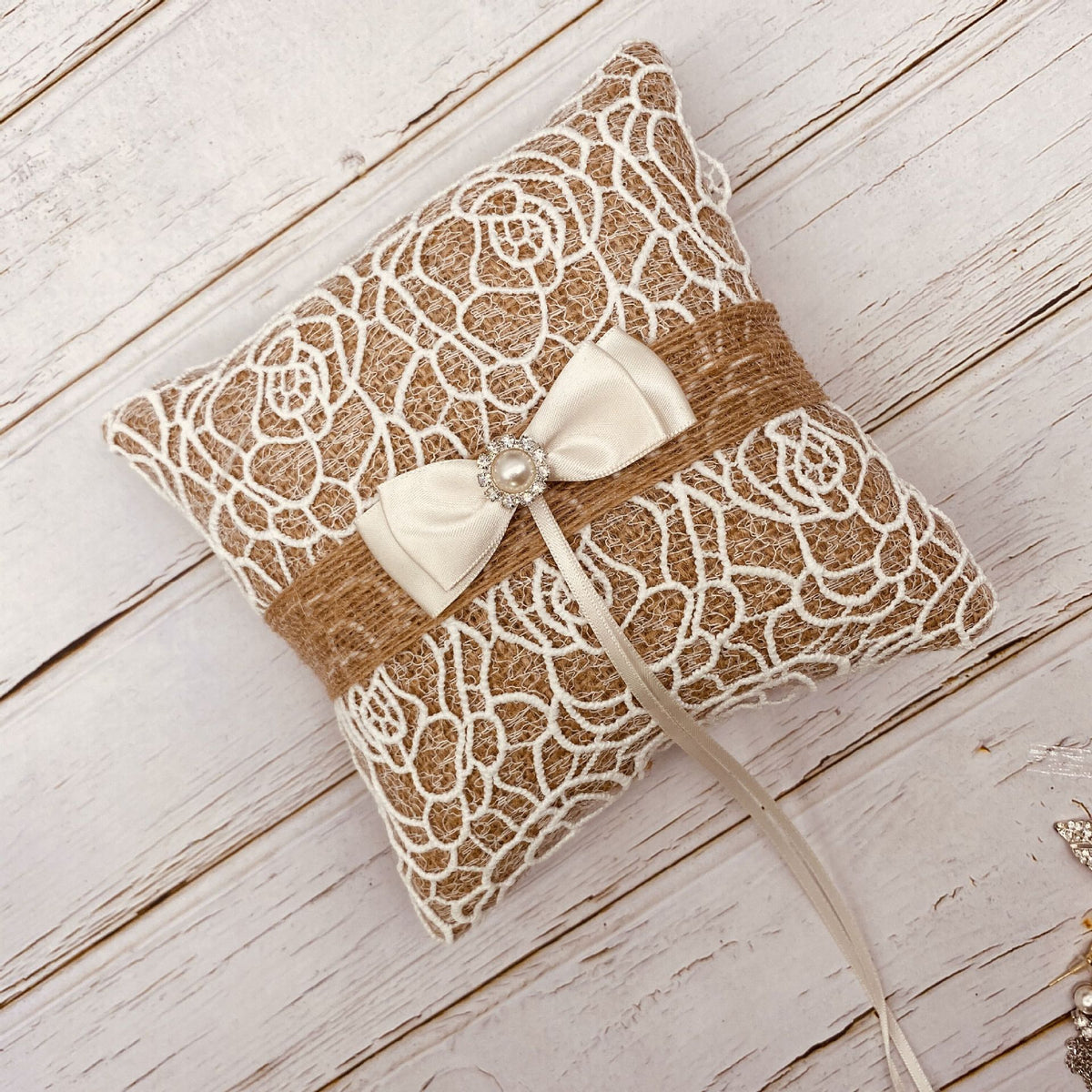 Wedding ring bearer pillow with ribbon bow and pearl-inspired accent