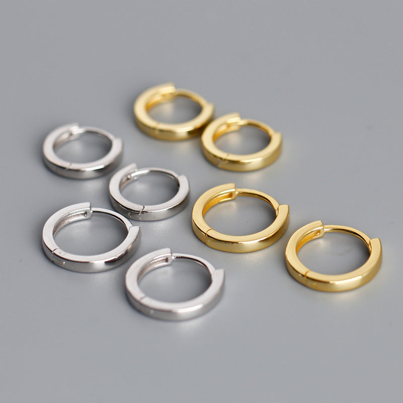 Gold tone and white gold tone huggie hoop earrings