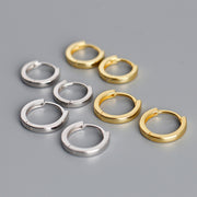 Gold tone and white gold tone huggie hoop earrings