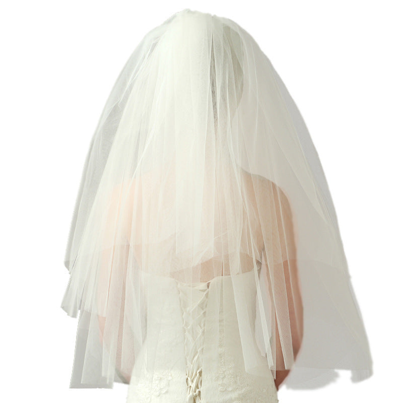 Back view of the Juliette layered bridal veil showing its sheer mesh and clean finished edges