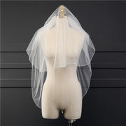 Front view of the Elise sheer bridal veil with a hair comb displayed on a dress form