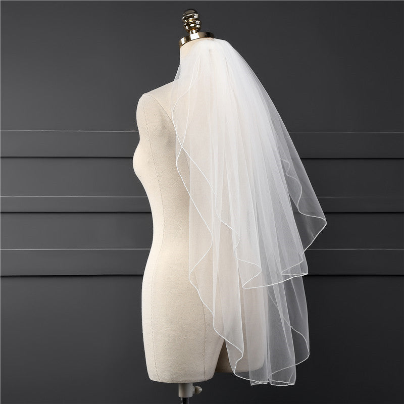 Side view of the Elise short bridal veil showing its soft layered drape and lightweight mesh