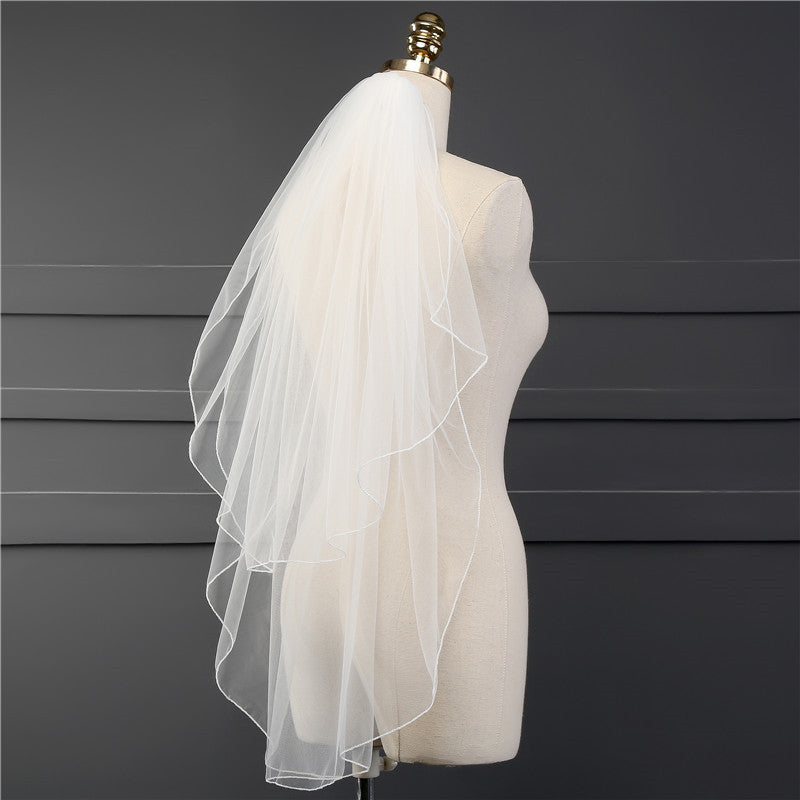 Back view of the Elise minimalist bridal veil with sheer fabric and a clean finished edge