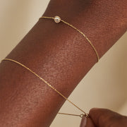 Close-up of the Margot fine gold-tone bracelet and adjustable chain worn on the wrist