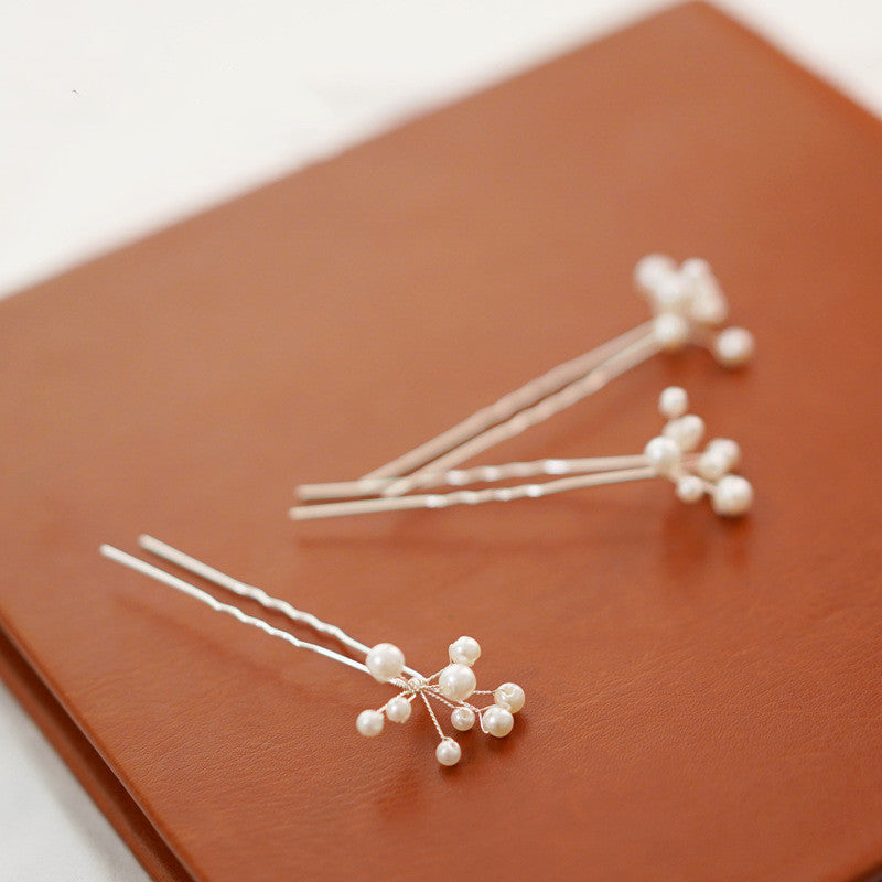 Delicate white pearl-style hair pin for romantic bridal updos