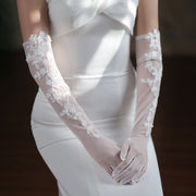 Long ivory-white wedding gloves with floral lace accents