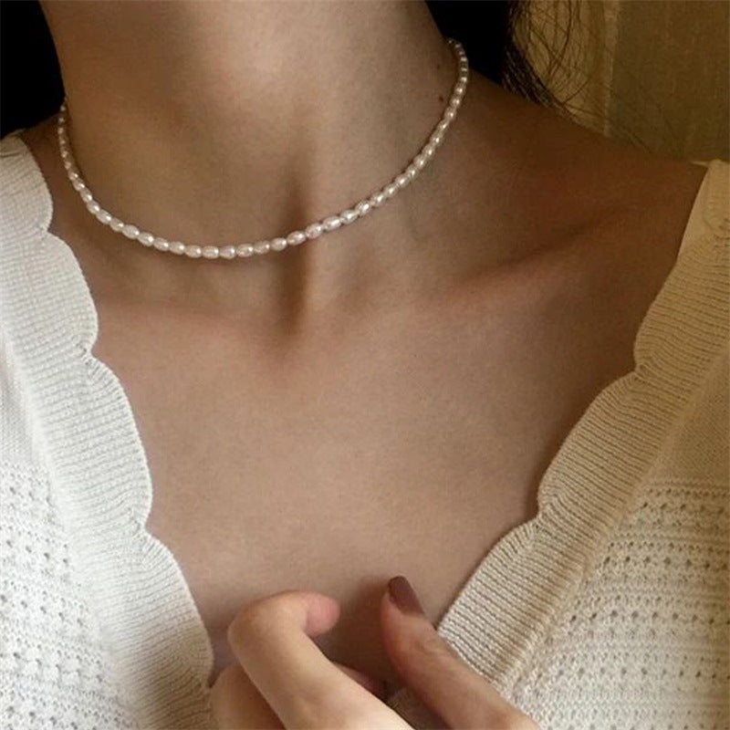 The Audrey delicate faux pearl necklace styled with a white textured blouse