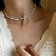 The Audrey delicate faux pearl necklace styled with a white textured blouse