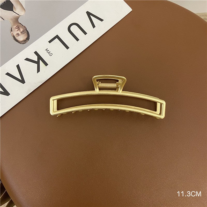 Minimal gold metal claw clip for everyday hair