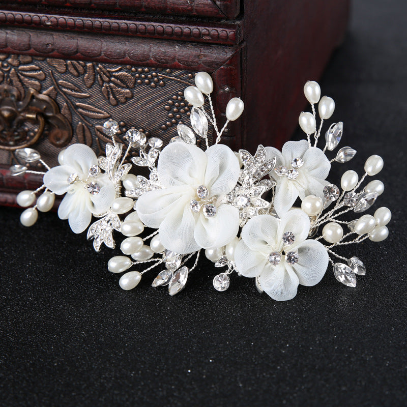 Pearl Blossom bridal hairpiece featuring crystal-style floral detailing
