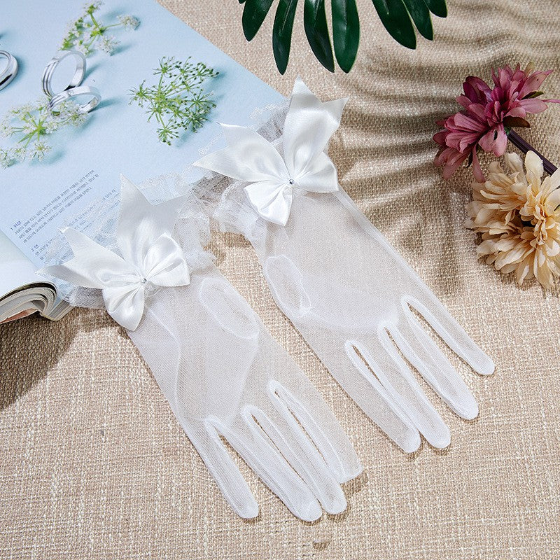 White mesh wedding gloves featuring romantic ruffled wrist cuffs