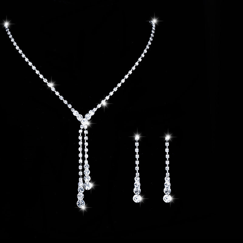 Seraphina crystal-style tassel necklace and matching drop earrings displayed together on a black background