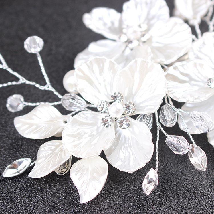 Romantic white floral bridal hairpiece for low buns and updos