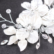 Romantic white floral bridal hairpiece for low buns and updos