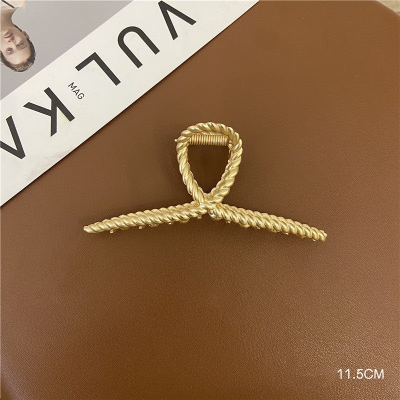 Margot polished gold hair claw accessory