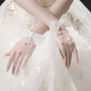 Elodie sheer white bridal gloves with pearl-style details and bows