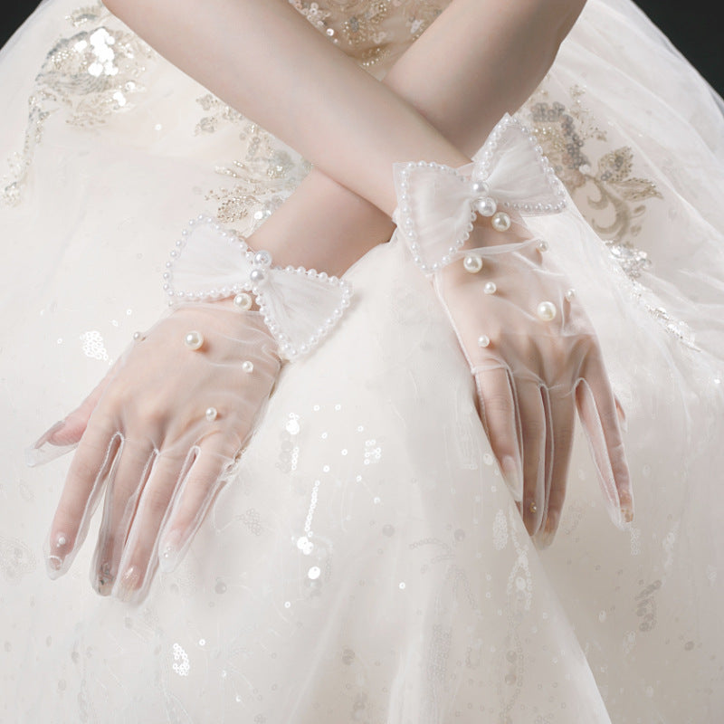 Elodie sheer white bridal gloves with pearl-style details and bows