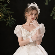 Bride wearing elegant gloves in a botanical portrait