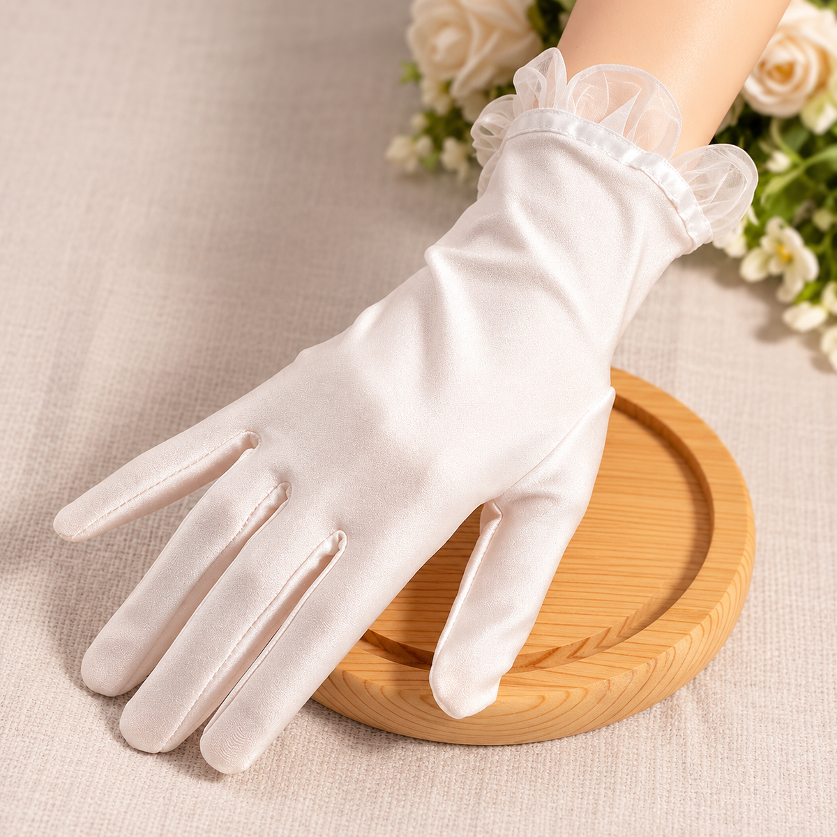 Elegant white satin bridal gloves styled in a bridal still life