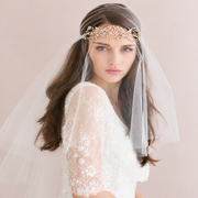 Bridal portrait with pearl headpiece and crystal-accented soft veil