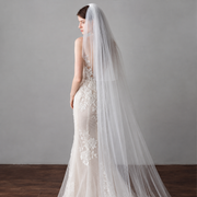 Elegant bridal portrait featuring the Amélie minimalist two-tier cathedral veil