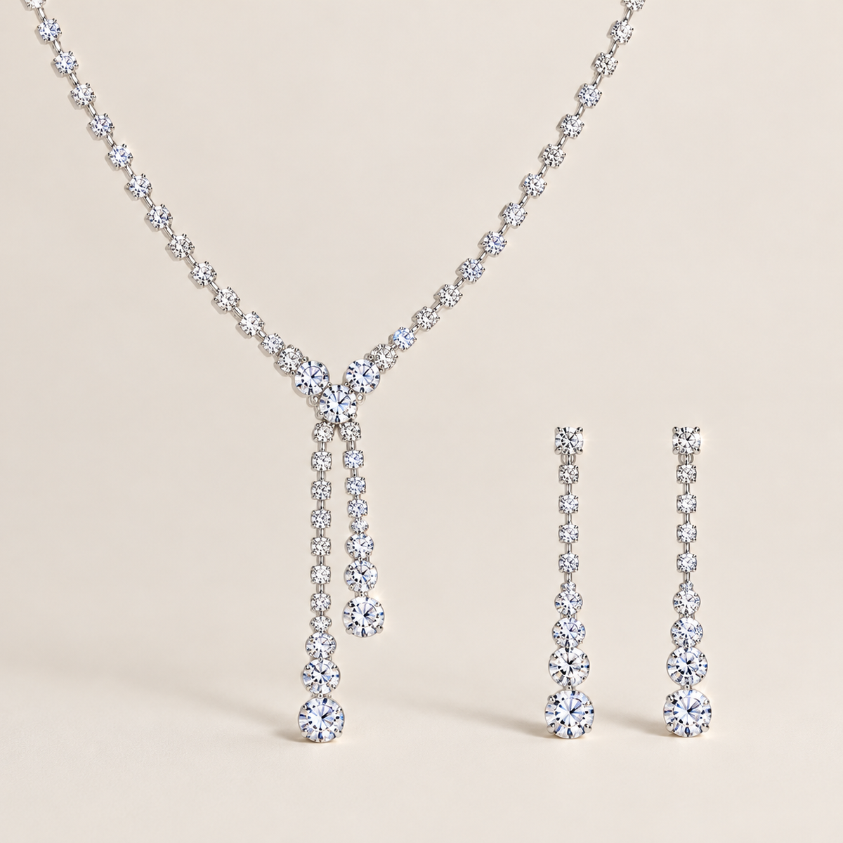 Seraphina bridal jewelry set featuring a silver-tone Y-shaped tassel necklace and matching earrings on a beige background