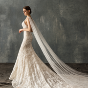 Elegant ivory lace bridal portrait featuring the Seraphina crystal cathedral veil