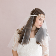 Ethereal bridal portrait with sheer veil and crystal accessories