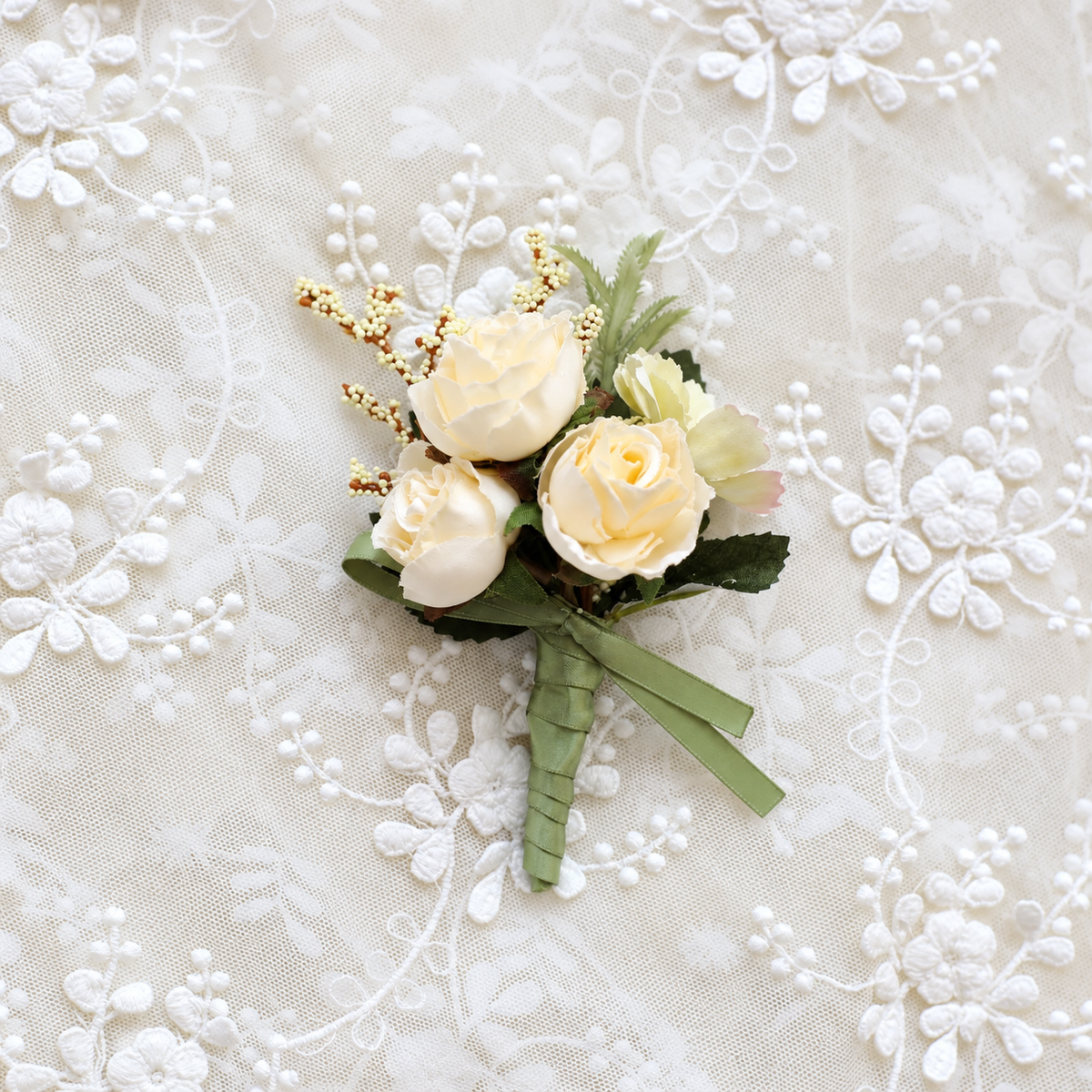 Ivory rose floral accessory displayed on lace