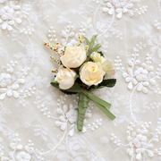 Ivory rose floral accessory displayed on lace