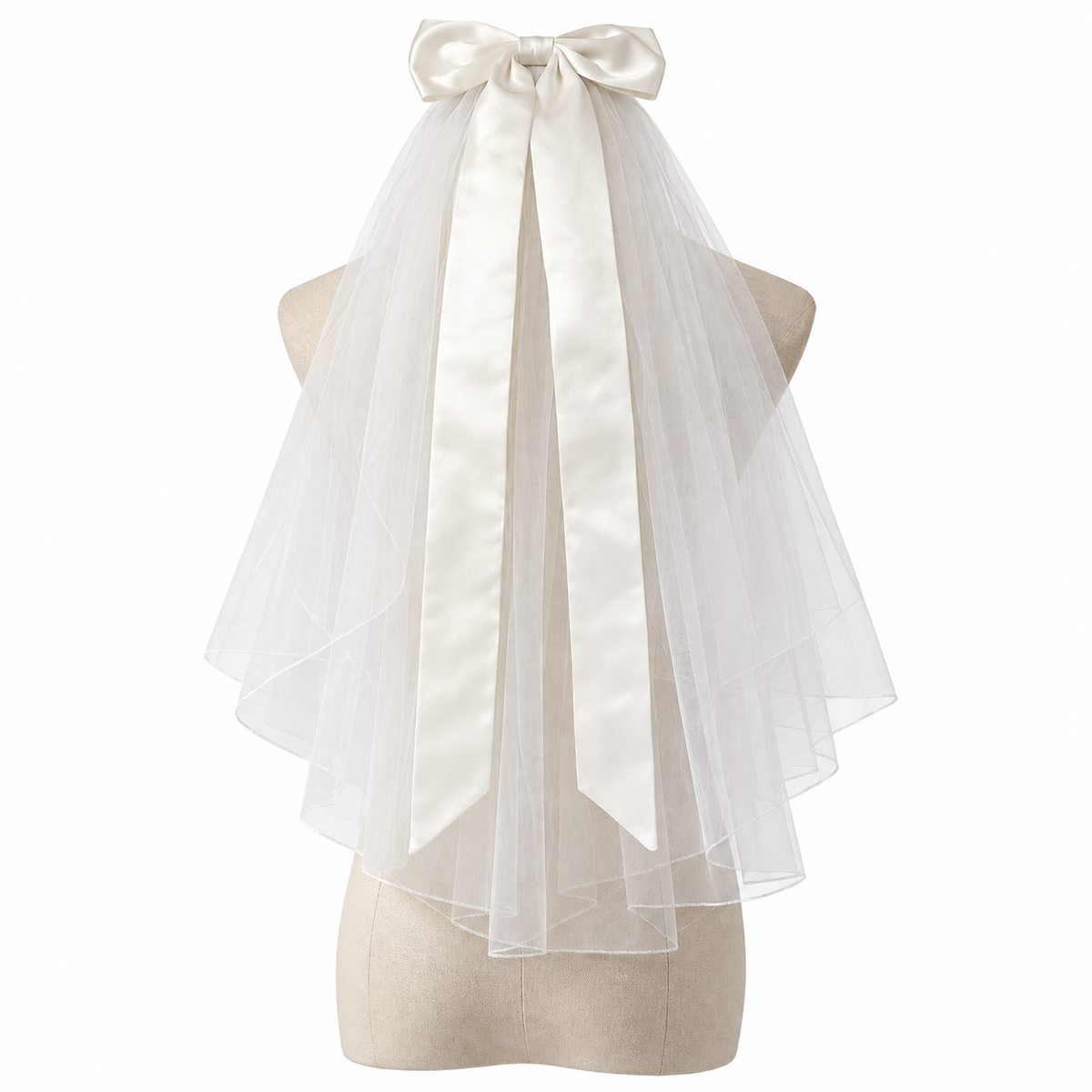 Colette short bridal veil with a large satin-style bow and long ribbon tails displayed on a dress form