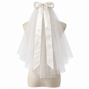 Colette short bridal veil with a large satin-style bow and long ribbon tails displayed on a dress form