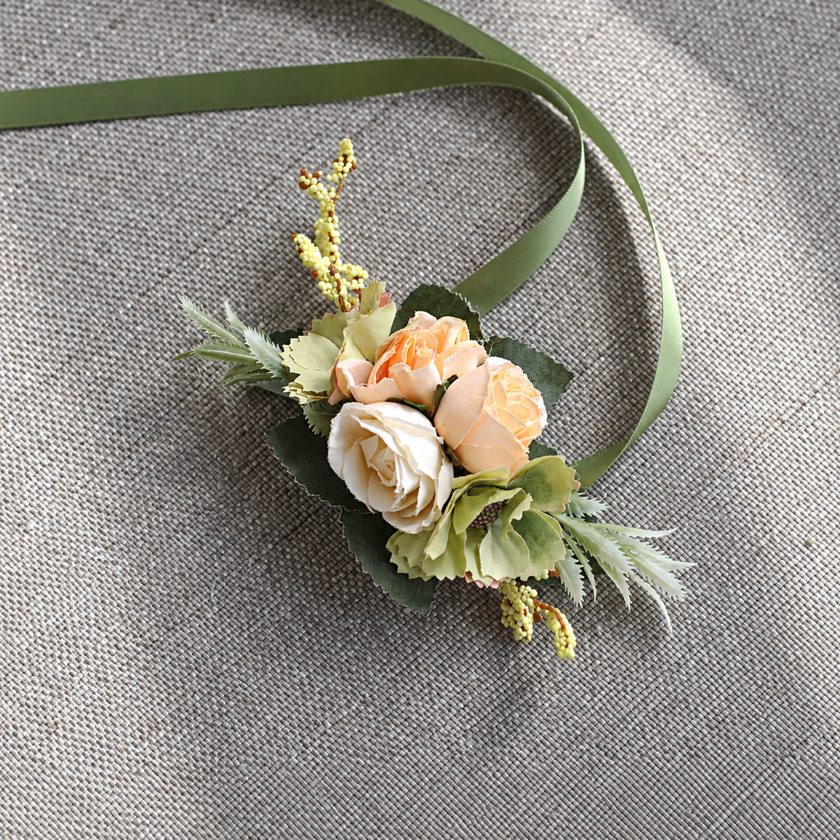 Pastel floral corsage accented with a green ribbon
