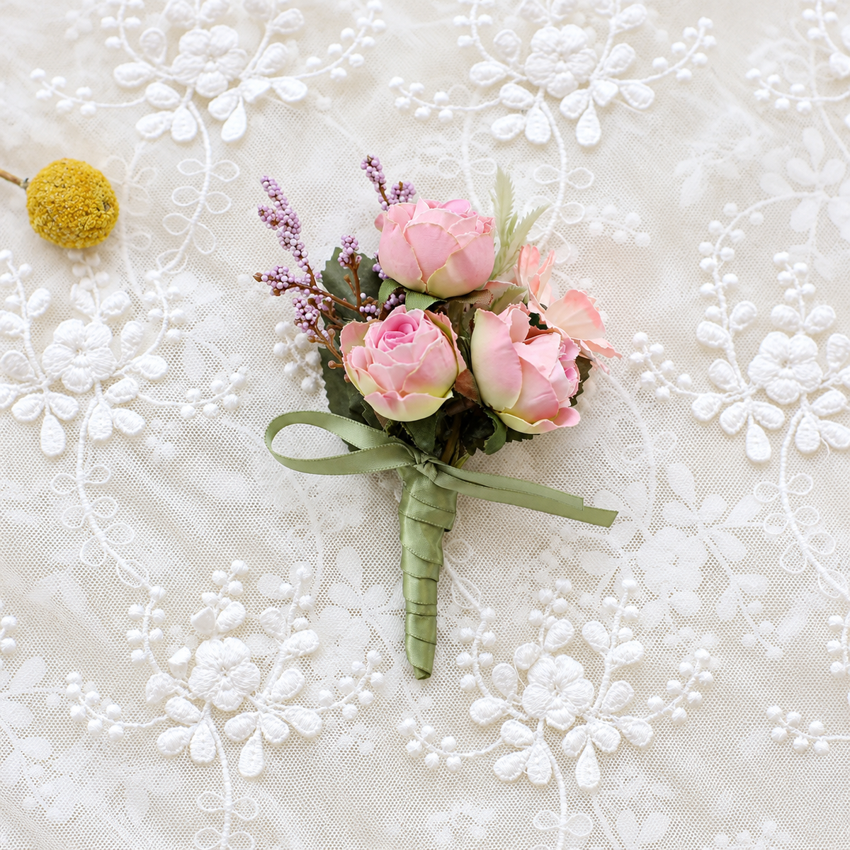 Pastel rose floral accessory displayed on lace