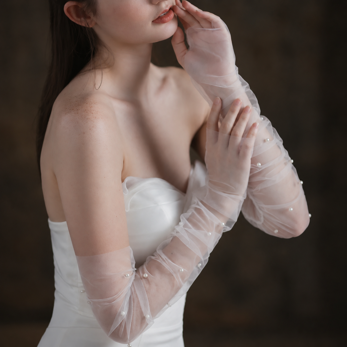 Bridal portrait featuring sheer gloves with pearl accents
