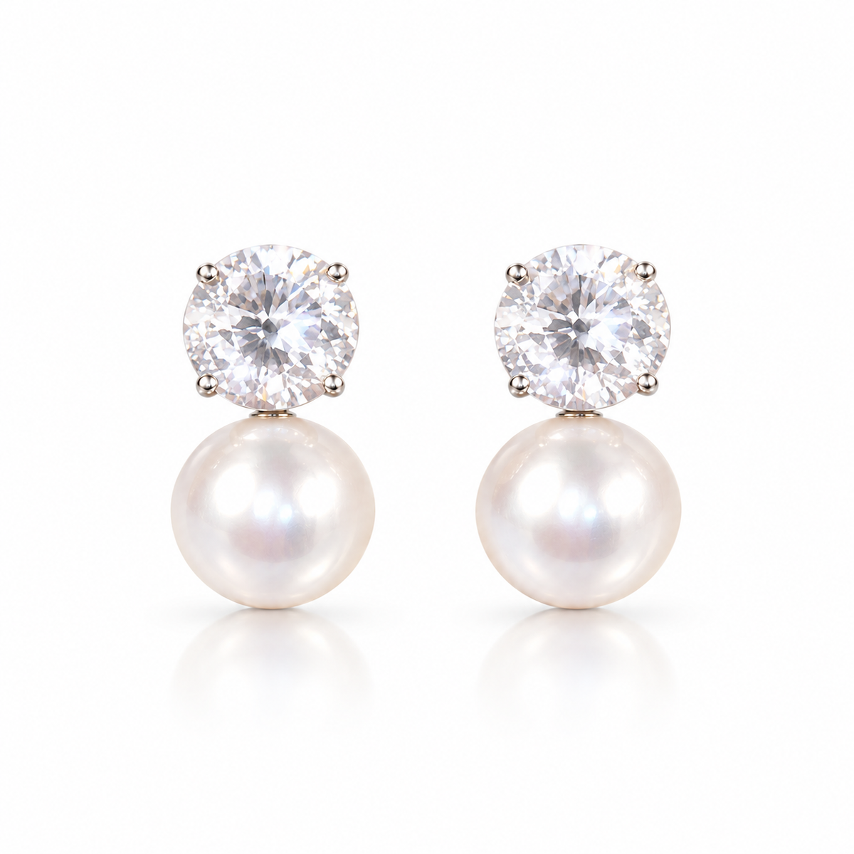 Pearl and diamond-style drop earrings with a halo design