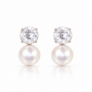 Pearl and diamond-style drop earrings with a halo design