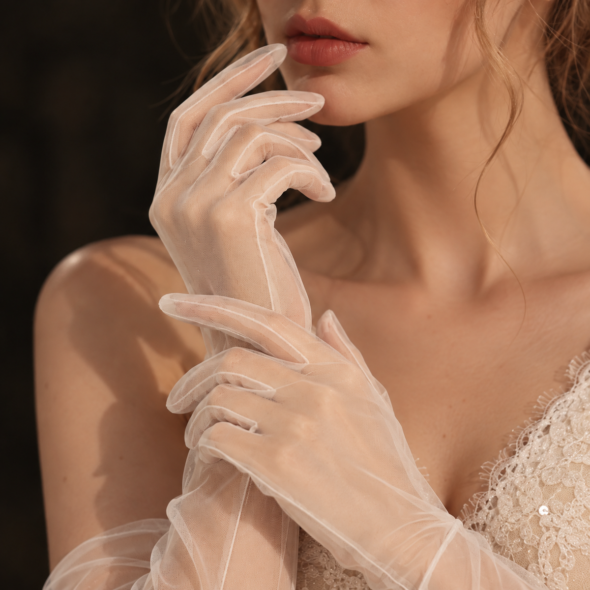 Bride wearing sheer tulle opera gloves with lace bridal styling