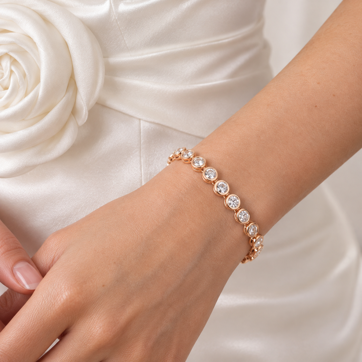 Model wearing the Celeste rose gold-tone bracelet with sparkling round stones and an ivory bridal dress