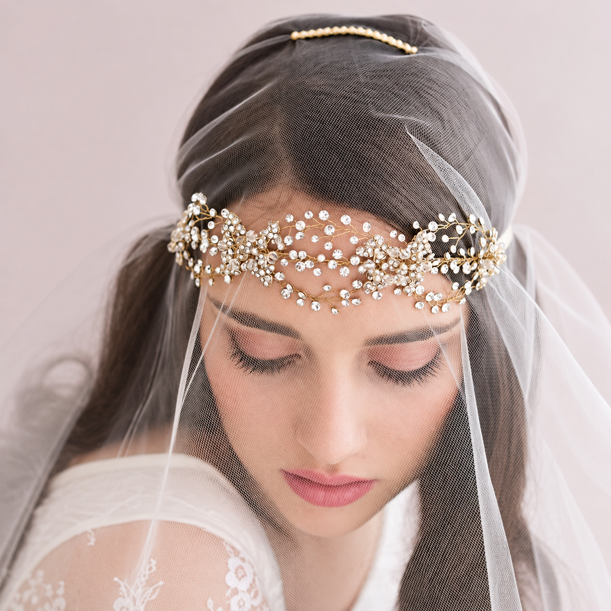 Bride wearing a crystal floral crown with a soft sheer veil