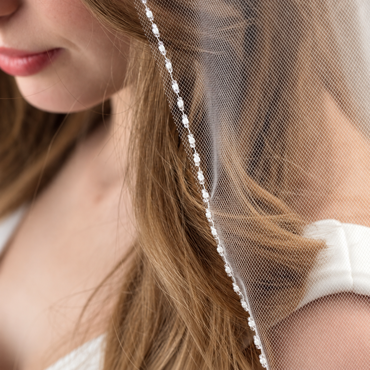 Veiled bride with pearl trim — Colette Crystal-Edge Fingertip Bridal Veil