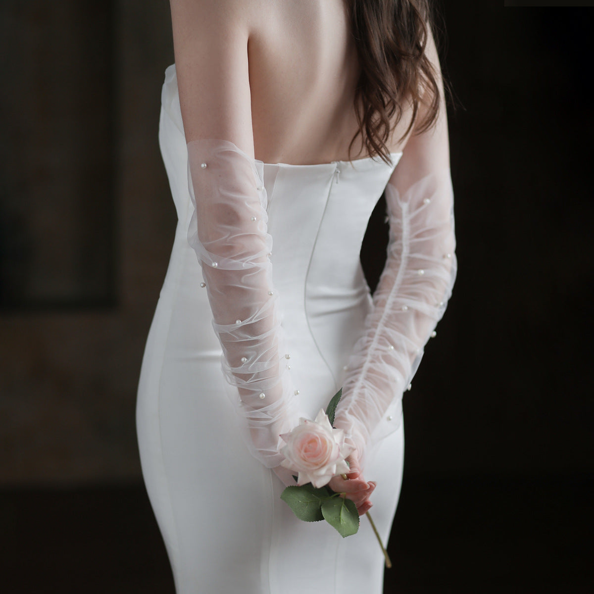Romantic white bridal gloves with scattered pearl details