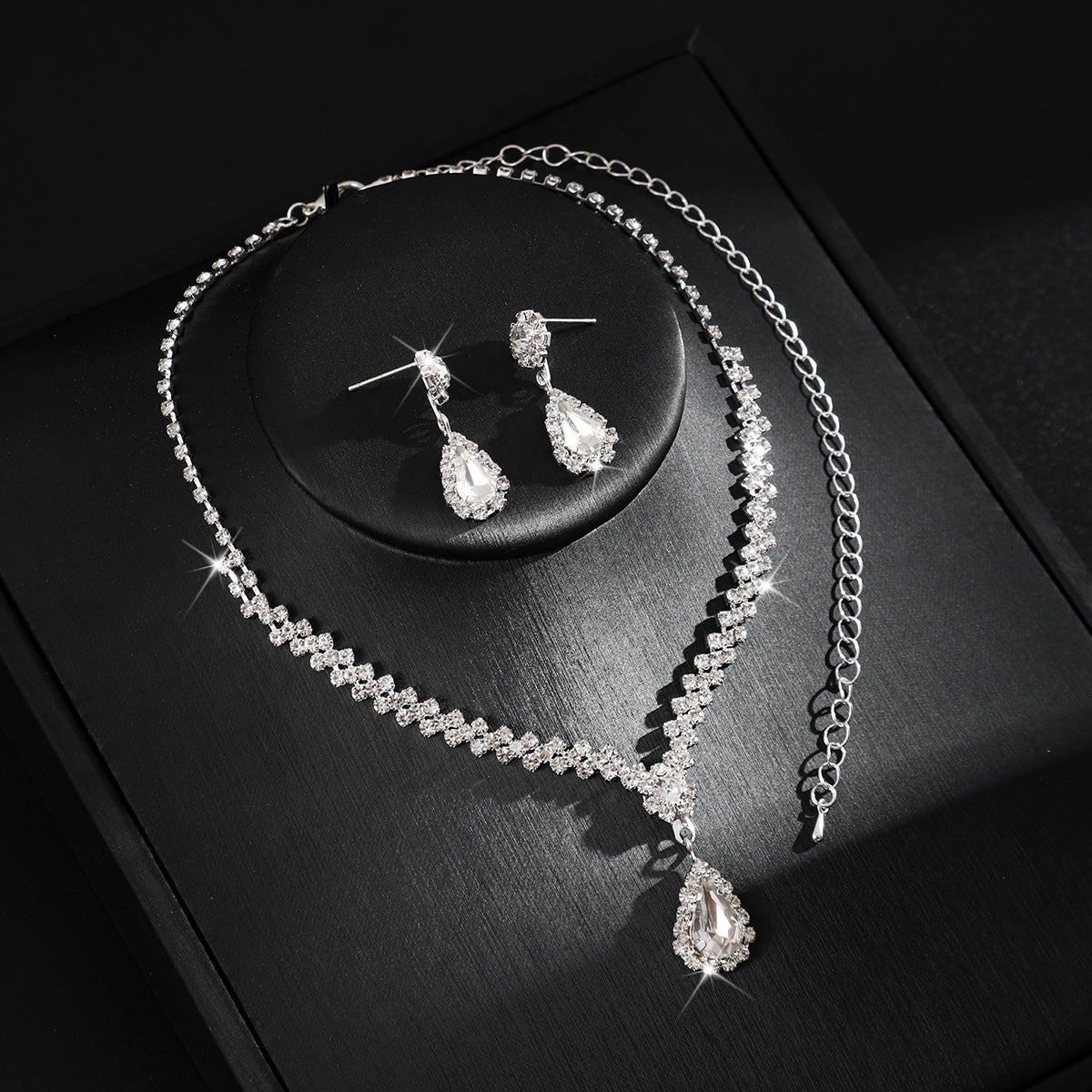 Matching wedding necklace and drop earrings with graduated crystal details