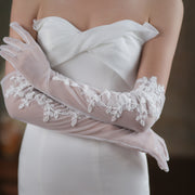 Sheer ivory floral lace wedding gloves in elegant long silhouette
