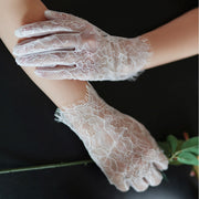Sheer floral-patterned ivory bridal gloves by Lumi Bride